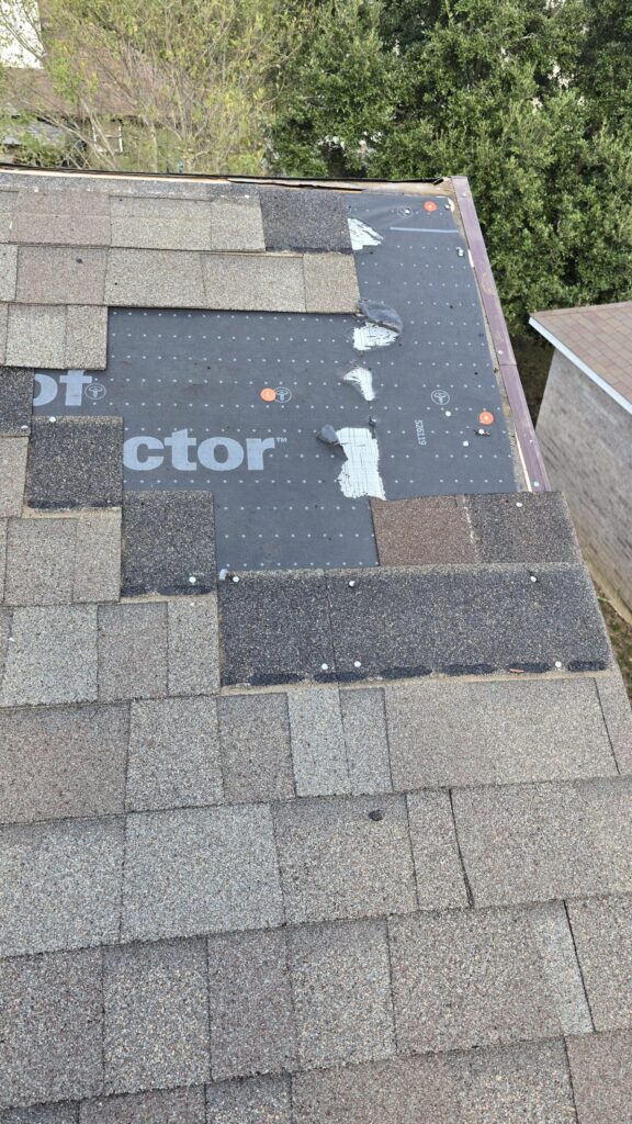 Roof edge repair with underlayment exposed and shingles partially installed near the eave.