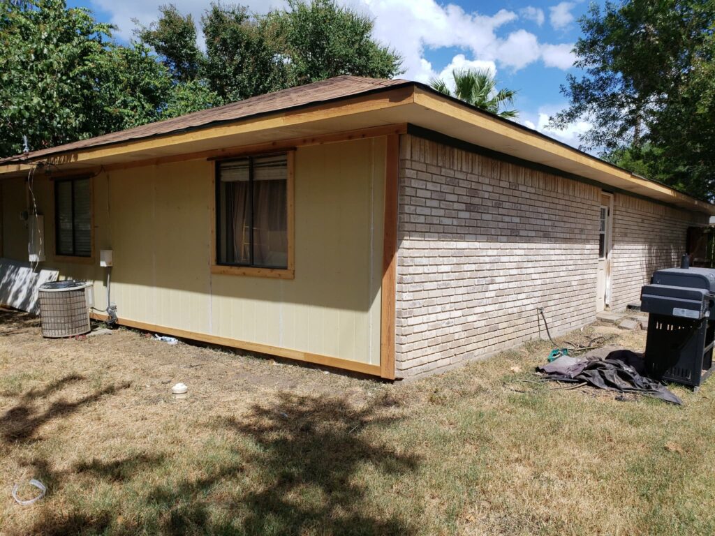 Exterior wall with siding and sliding glass door viewed from the deck
