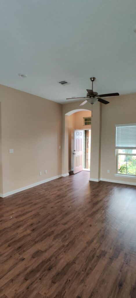 Updated kitchen interior with dark cabinets, granite countertop, and pendant lighting.