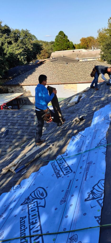 Roofer installing shingles and underlayment on a residential roof in Caldwell, Texas.